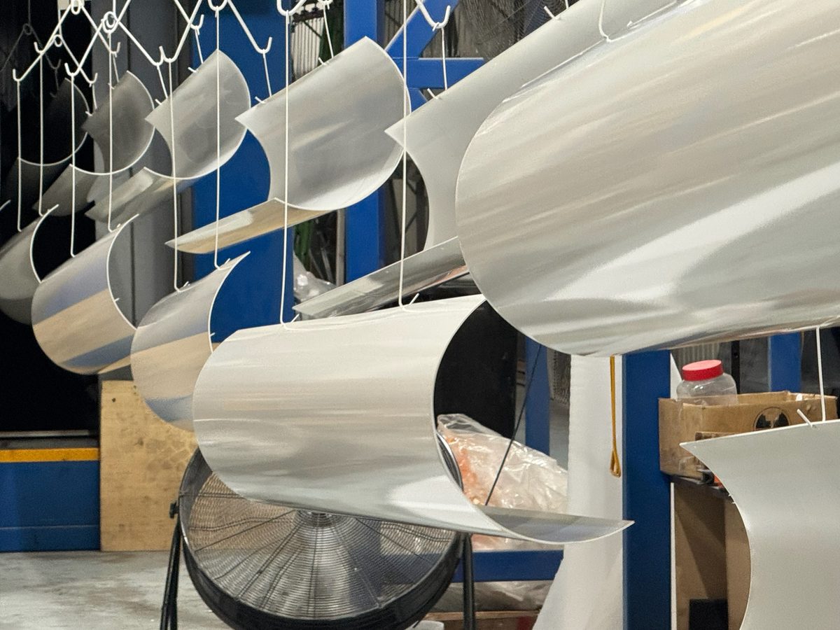 Aluminium curved panels hanging for powder coating — sheet metal fabrication Melbourne