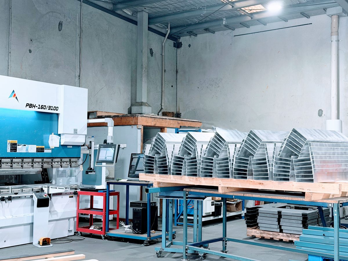 CNC press brake folding service with stacked formed sheet metal parts — Aston Precision Melbourne